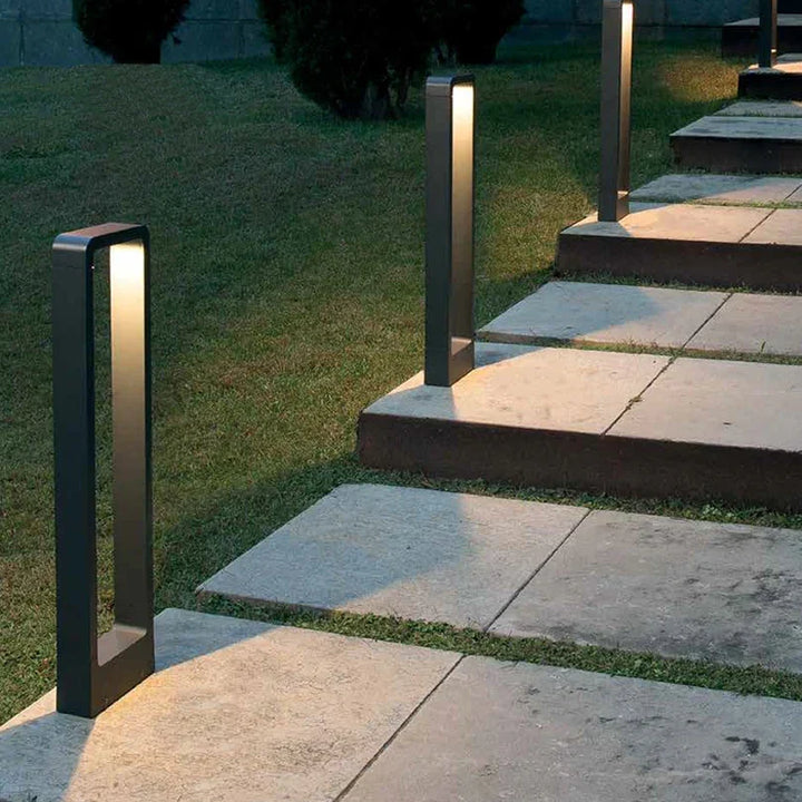 Elegant LED pathway lamp illuminates garden paths. Modern durable outdoor lighting for landscape and yard.