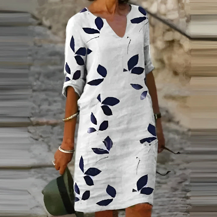 Women's flowing midi dress with elegant leaf print, perfect for autumn fashion & versatile day-to-night style.