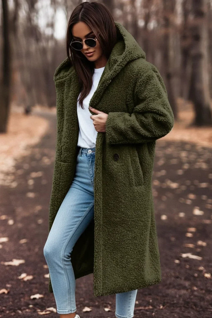 Cozy black oversized hooded winter coat for women, plush and warm. Stylish long-sleeve outerwear for cold weather.