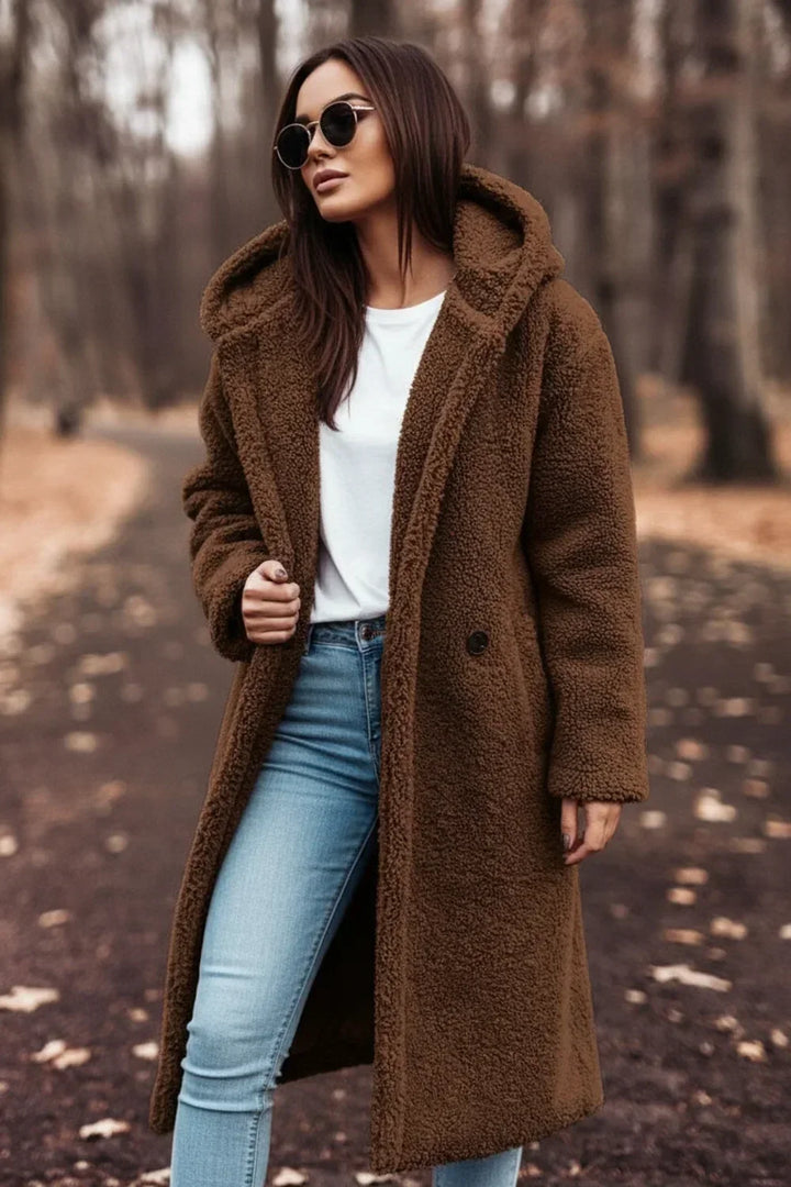 Model wearing a cozy oversized hooded winter coat, showcasing plush comfort and stylish button-front design.