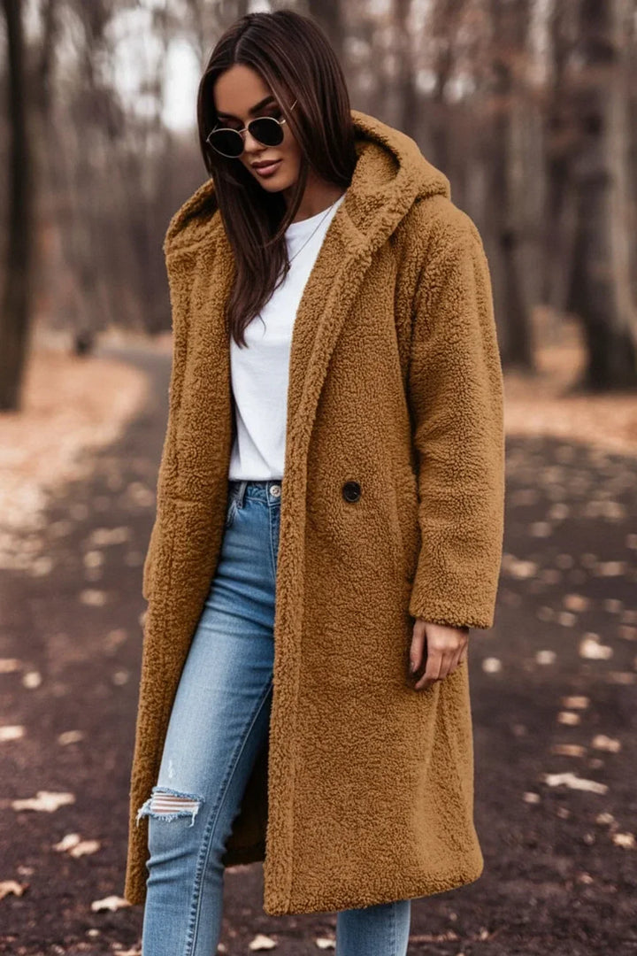 Close-up of the plush fabric on a women's cozy oversized hooded winter coat, highlighting its warmth and texture.
