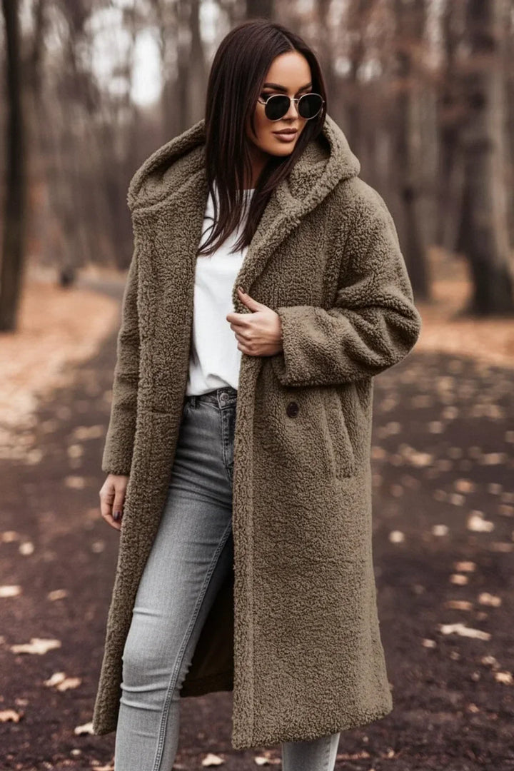 Back view of a women's oversized hooded winter coat, showcasing the cozy hood and long-sleeve design. Warm outerwear.