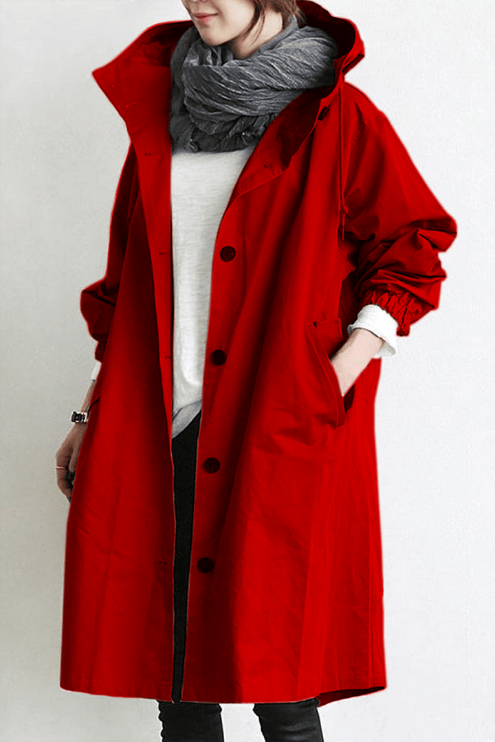 Woman wearing a lightweight hooded waterproof trench coat, walking stylishly in spring rain.
