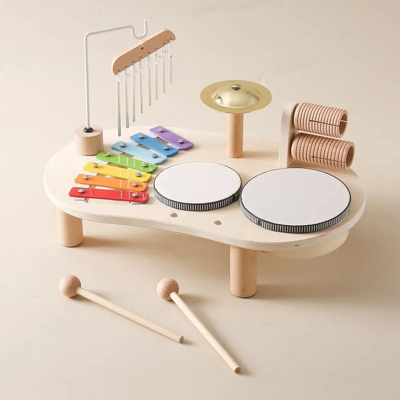 Toddler happily exploring wooden musical instruments; ideal for sensory play & early musical learning.