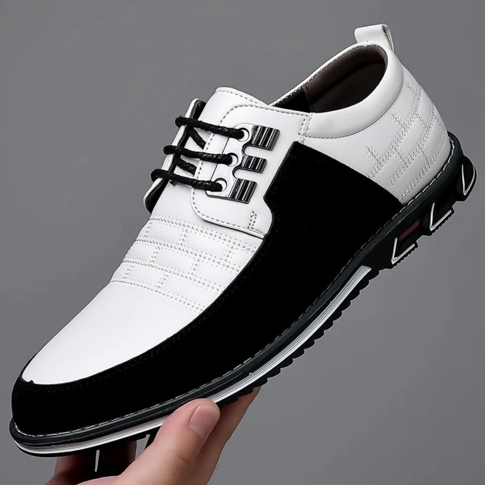 Close-up of polished black men's orthopedic lace-up shoes, highlighting stitching & comfort features.