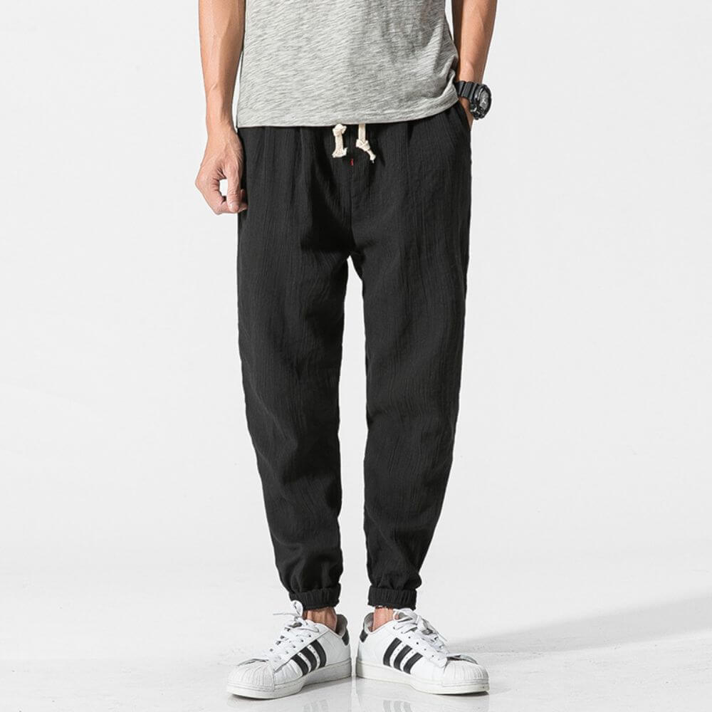 Comfortable men's tapered linen pants with elastic cuffs, designed for a relaxed everyday fit.