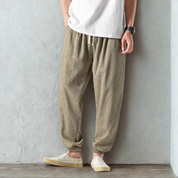 Modern men's tapered joggers, linen fabric for travel or daily comfort. Drawstring waist for fit.