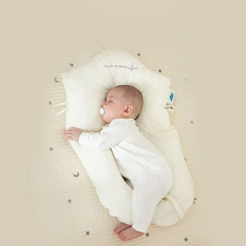 Soft baby pillow providing gentle head & neck support for safe infant sleep. Hypoallergenic design for newborns.