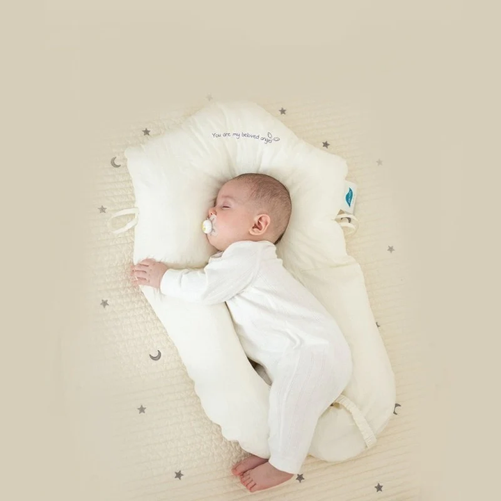 Soft baby pillow providing gentle head & neck support for safe infant sleep. Hypoallergenic design for newborns.
