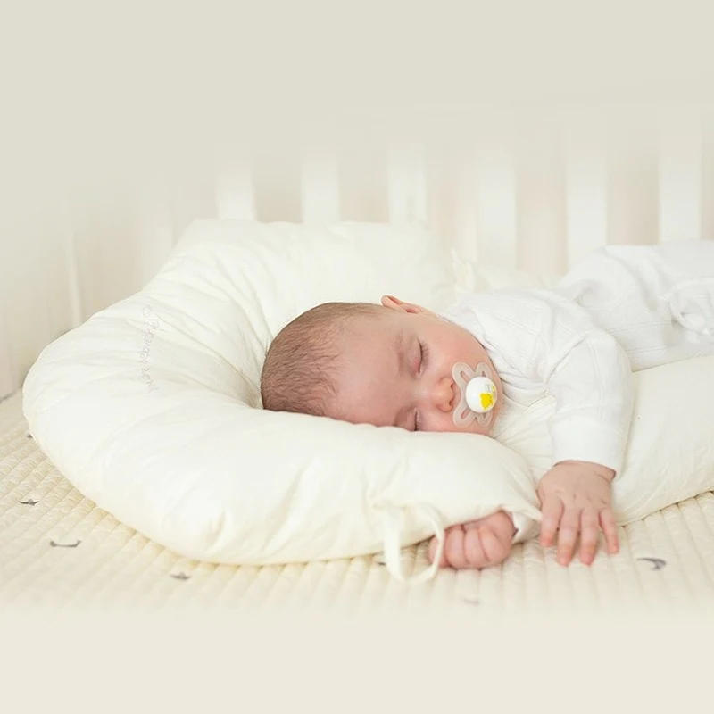 Plush, hypoallergenic infant sleep pillow ensures safe, gentle comfort & head support for restful baby sleep.