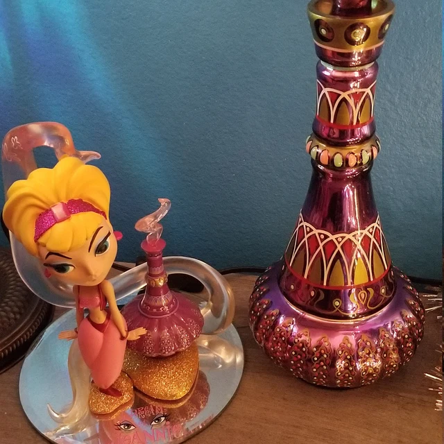 Intricate purple glass genie bottle, collectible and enchanting fantasy decor.