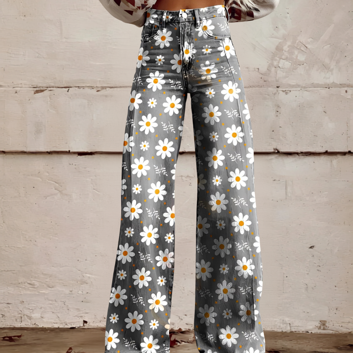 Women's high waist wide leg jeans with vibrant floral print. Stylish patterned denim for unique casual wear.