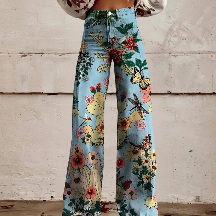 Women's high waist wide leg floral jeans styled with a top. Fashion-forward patterned trousers outfit.