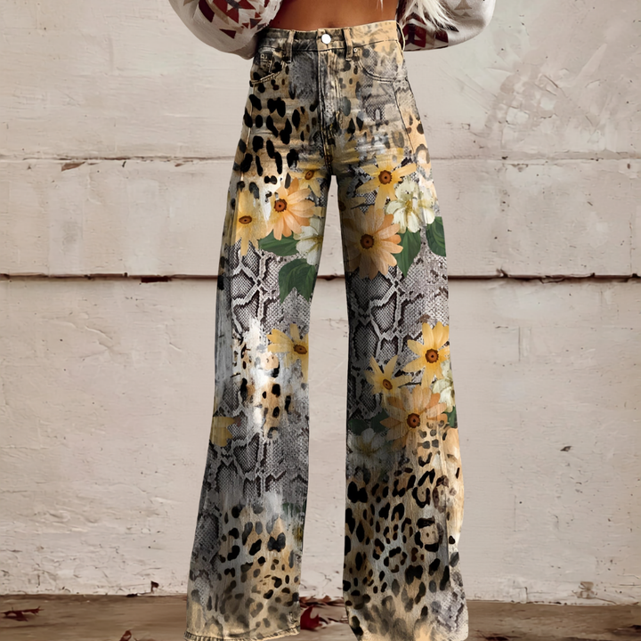Back view of women's high waist wide leg floral jeans. Stylish casual wear with unique floral print.