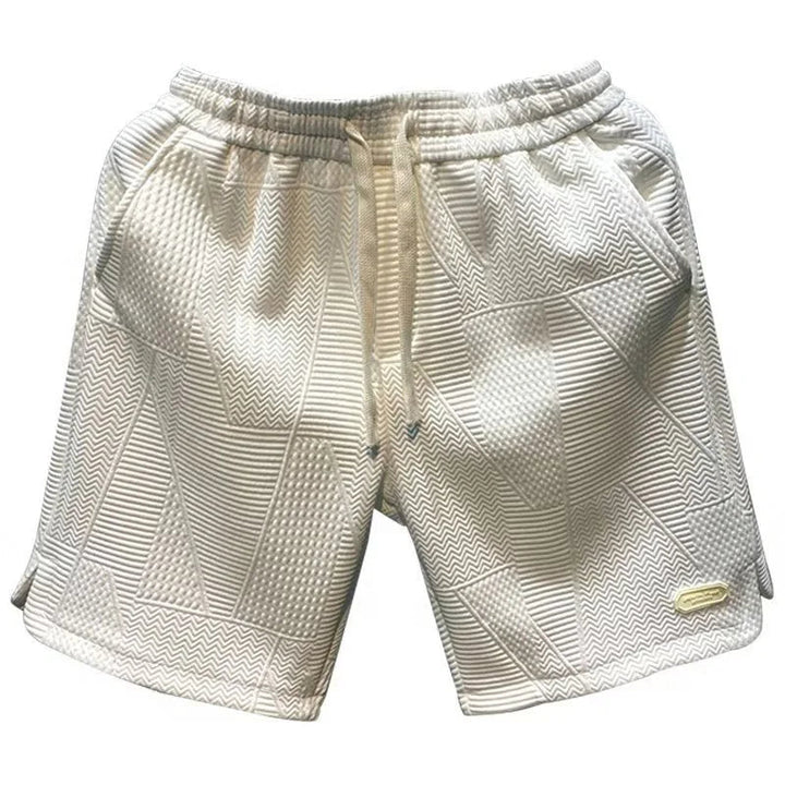 Man wearing cool herringbone summer shorts, perfect for beach or casual outings.