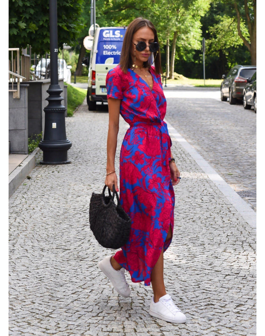 Women's elegant party maxi dress with vibrant floral print and a chic belt for evening wear.
