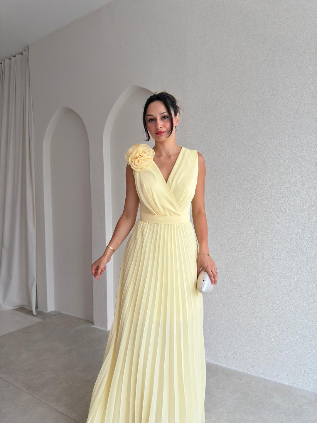 Graceful women's pleated cocktail dress with delicate floral appliqué. Perfect A-line evening gown for special occasions.