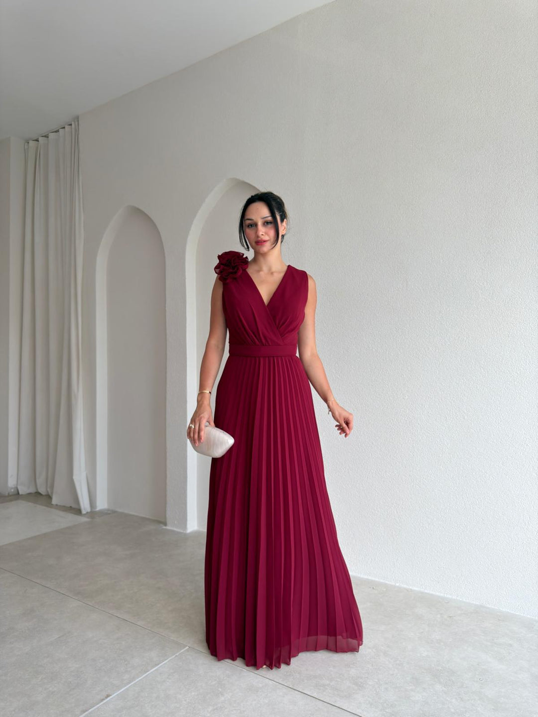 Beautiful floral appliqué detail on a women's pleated A-line cocktail dress. Perfect for elegant party wear.