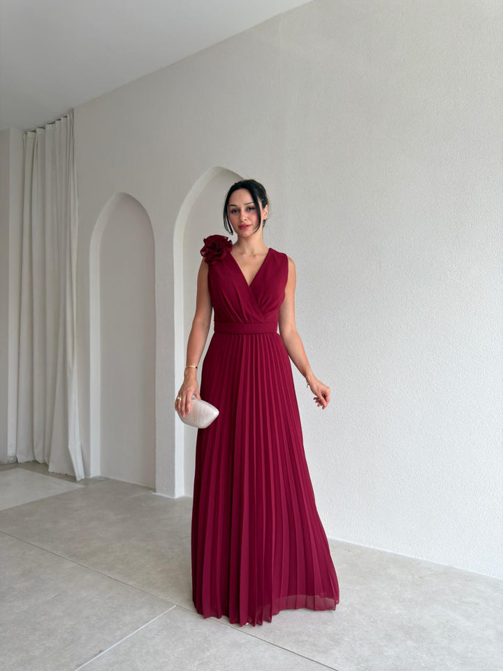 Beautiful floral appliqué detail on a women's pleated A-line cocktail dress. Perfect for elegant party wear.