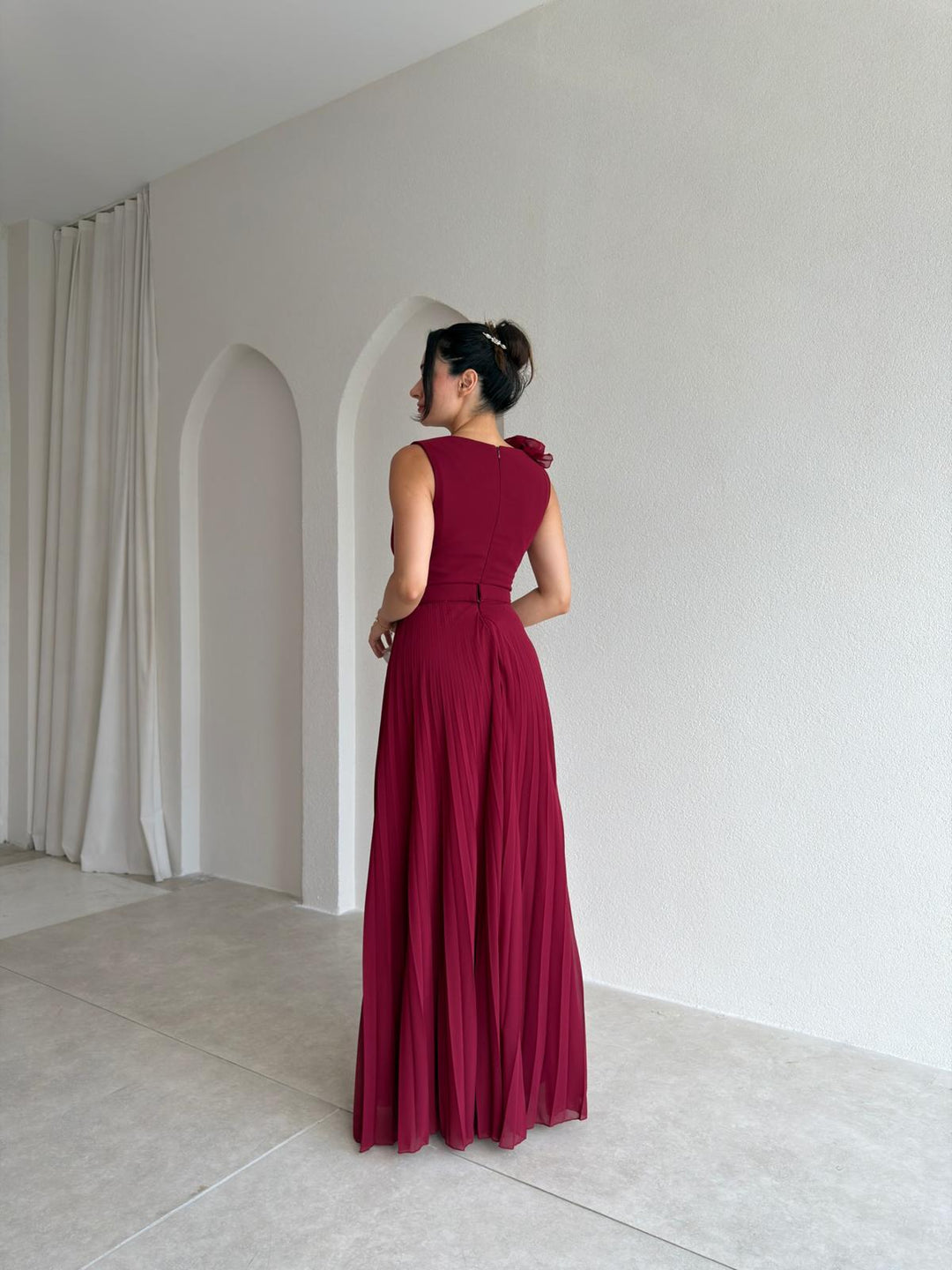 Sophisticated women's pleated cocktail dress with v-neck and charming floral appliqué. An ideal formal evening dress.