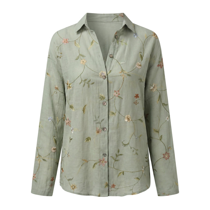 Casual women's blouse with vibrant abstract print, V-neck, adjustable roll-up sleeves. Everyday.