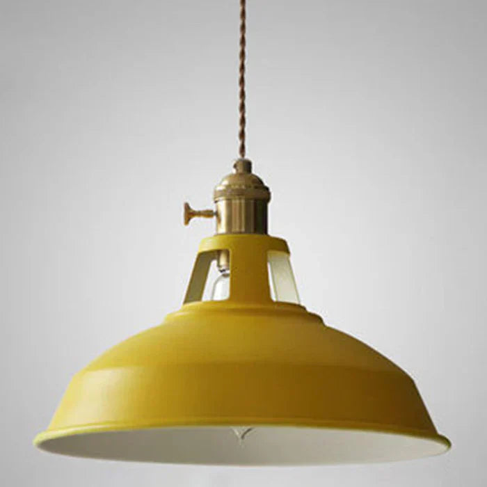Dining room pendant light with a vintage industrial aesthetic and metal shade.
