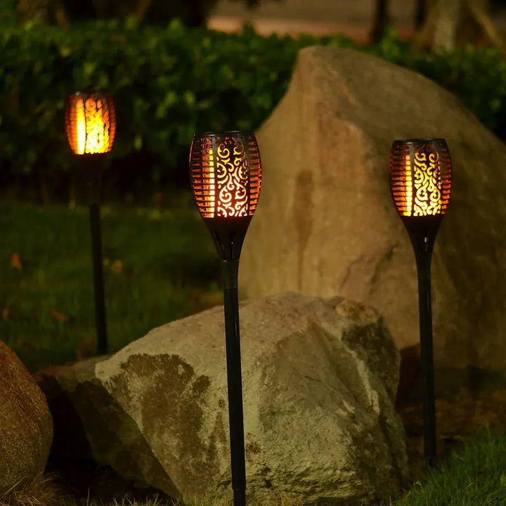 Yard solar torch light, offering a beautiful, safe flickering LED flame for outdoor garden decoration.