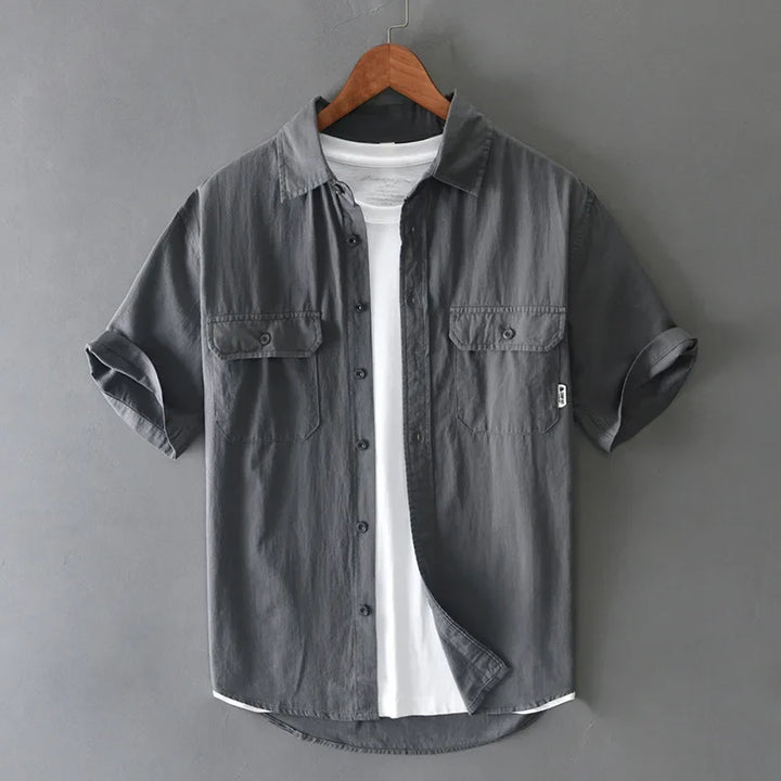 Versatile men's gray short sleeve fishing shirt with twin pockets, ideal for travel, workwear style, and summer.