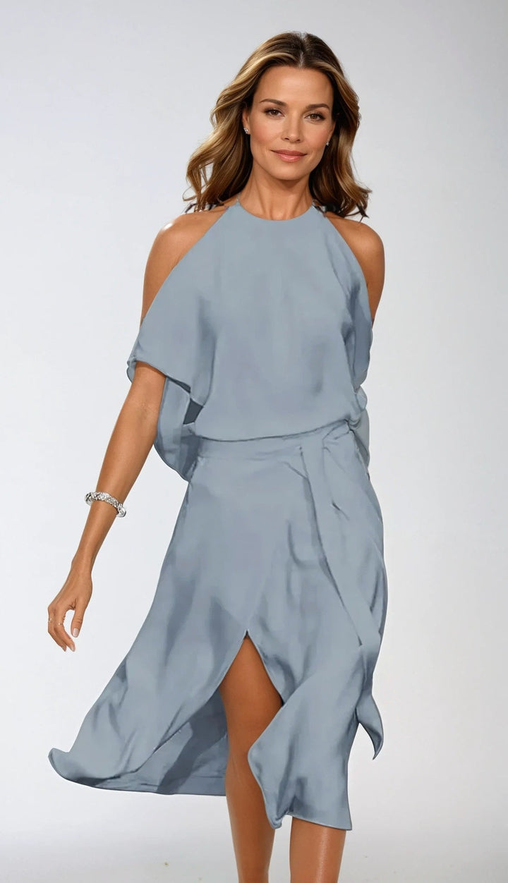 Stylish black women's cold shoulder midi dress with halter neck & asymmetrical hem. Ideal formal or party wear.