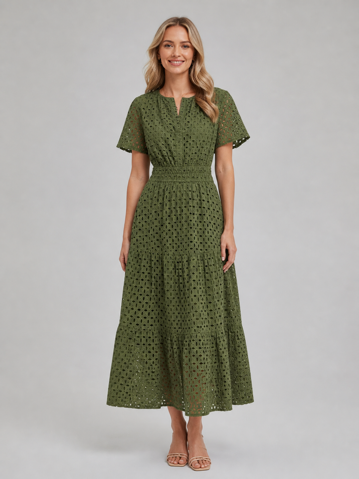 Women's white eyelet A-line midi dress with flutter sleeves, perfect for summer casual or vacation outfits.
