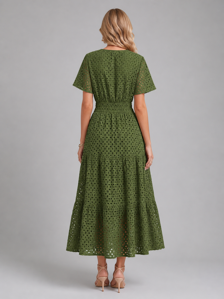 Elegant women's eyelet A-line midi dress, tiered skirt, and flutter sleeves for breathable summer comfort.