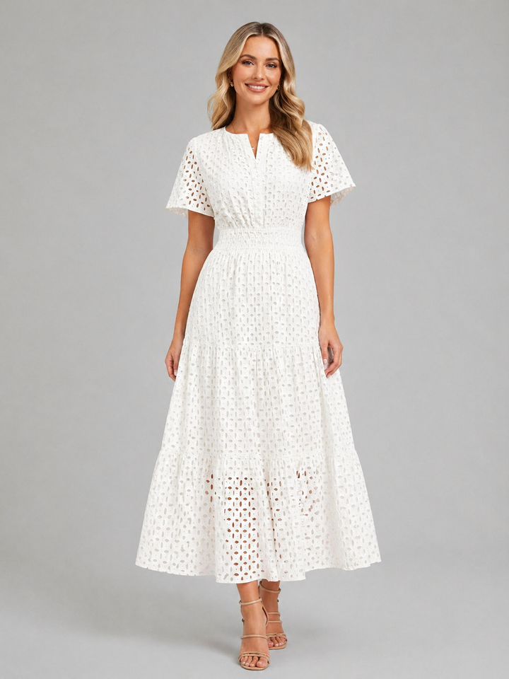 Casual women's eyelet A-line midi dress, ideal for vacation outfits or comfortable daytime wear. Effortless style.