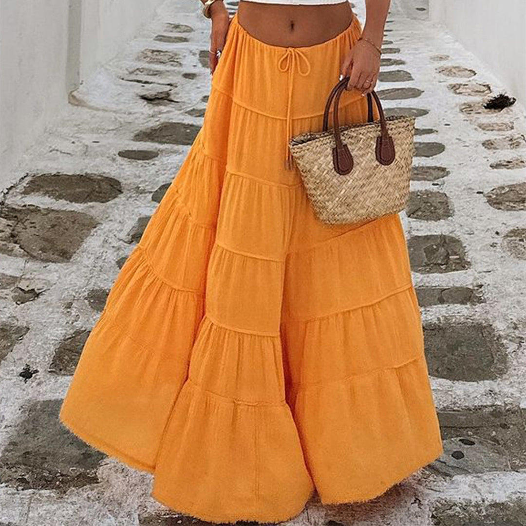 Women's chic tiered boho midi skirt with an elastic waistband, offering timeless style and a flowy silhouette.