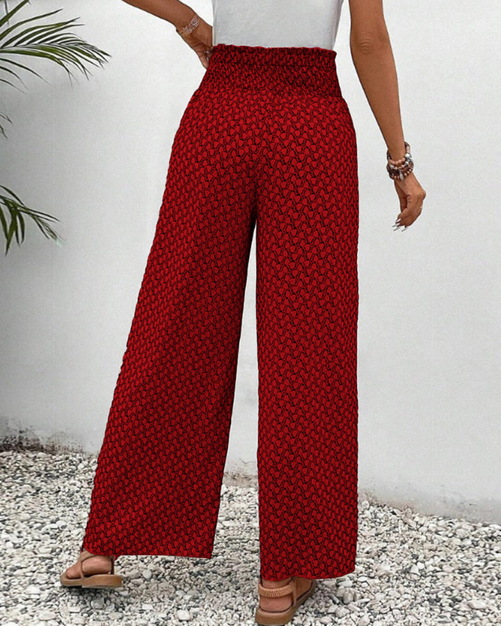 Close-up of the vibrant geometric print & drawstring high waist on stylish women's wide leg pants.