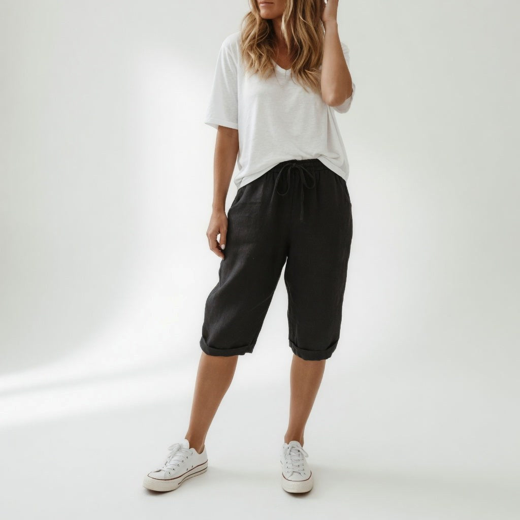 Model wears women's relaxed-fit Bermuda shorts, ideal for casual warm weather & summer days.