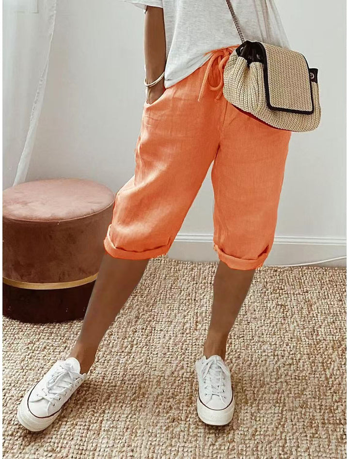 Close-up: fabric of women's relaxed-fit Bermuda shorts, soft & breathable for warm weather.