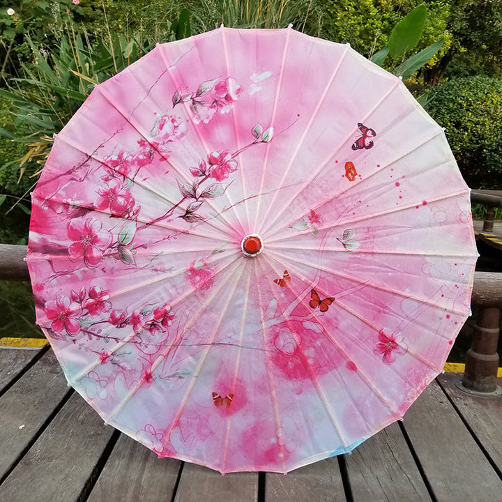 Elegant Japanese UV protection parasol with cherry blossom design & bamboo handle for summer sun.