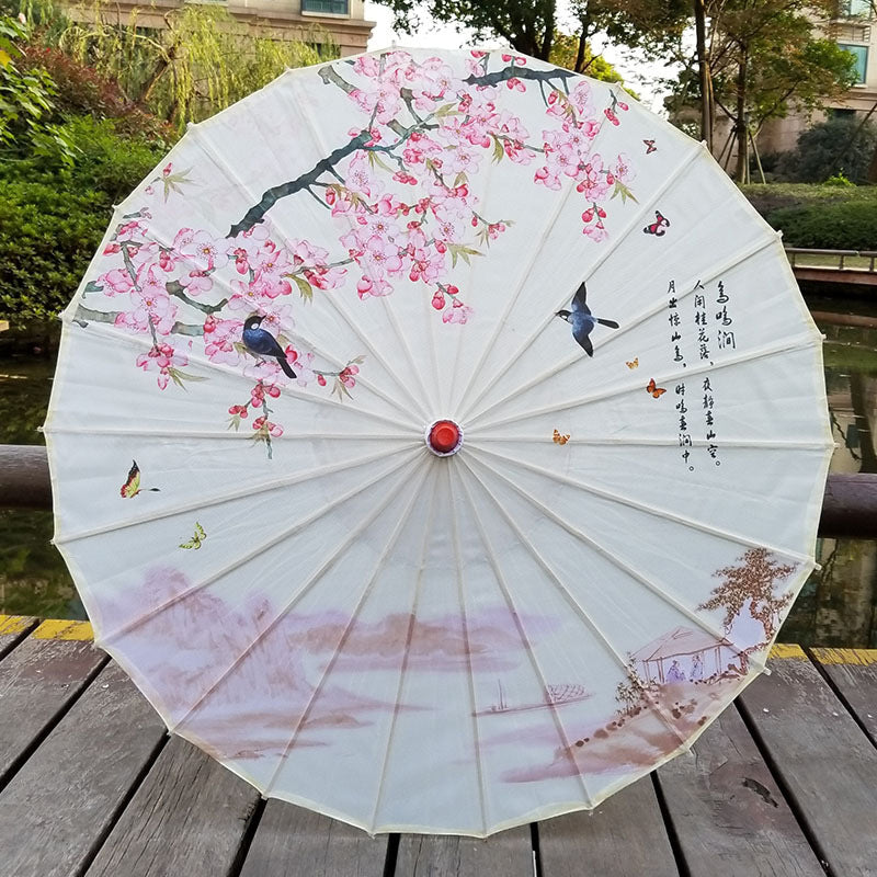 Traditional Japanese paper sun umbrella with UV protection & a stylish bamboo handle, perfect for sun protection.