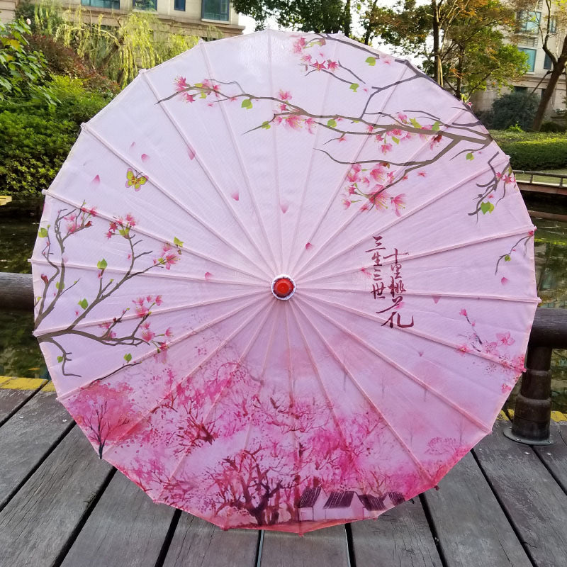 Portable Japanese style sun umbrella, offering UV protection. Elegant outdoor accessory for summer, features cherry blossoms.
