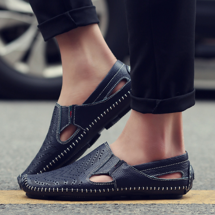 Breathable perforated men's slides, a classic summer sandal and comfortable slip-on.