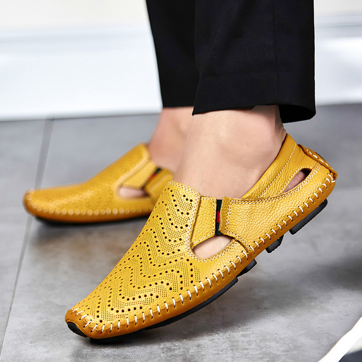 Lightweight men's perforated slides with woven detail, ideal for travel & pool sides.
