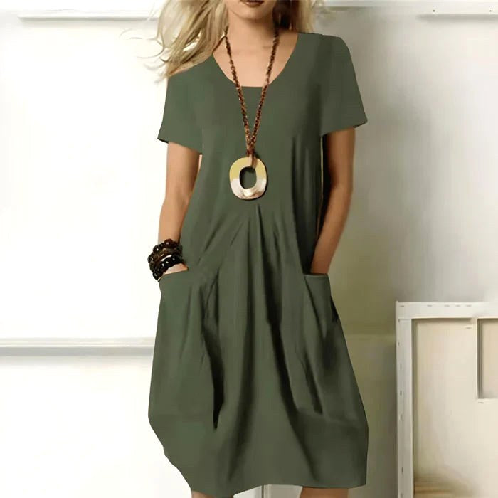 Women's short sleeve relaxed-fit casual dress with practical pockets, perfect for everyday comfort.