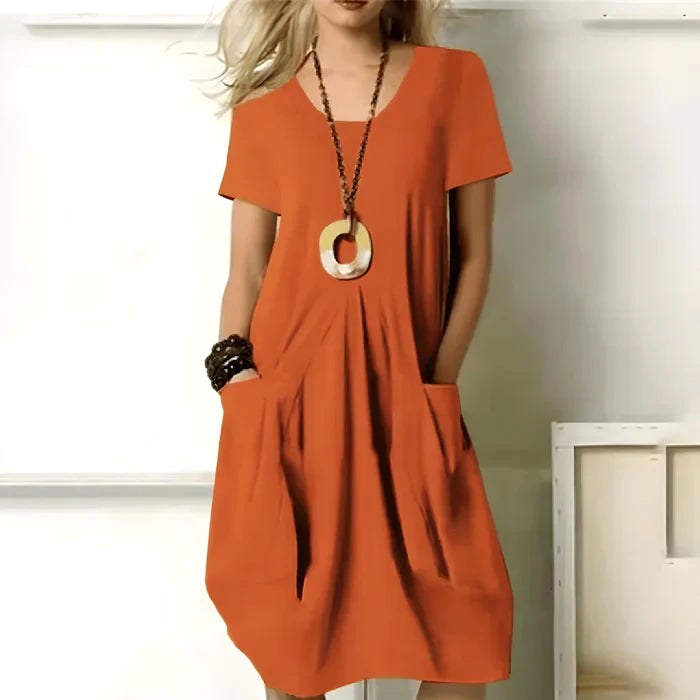 Chic women's short sleeve relaxed-fit dress, a versatile everyday piece with convenient side pockets.
