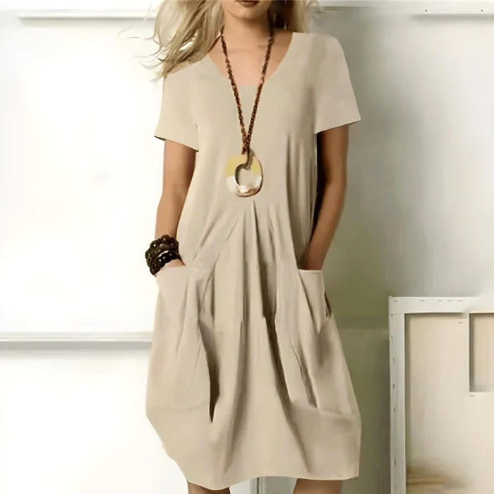 Stylish women's summer short sleeve dress featuring a comfortable relaxed fit and functional pockets.