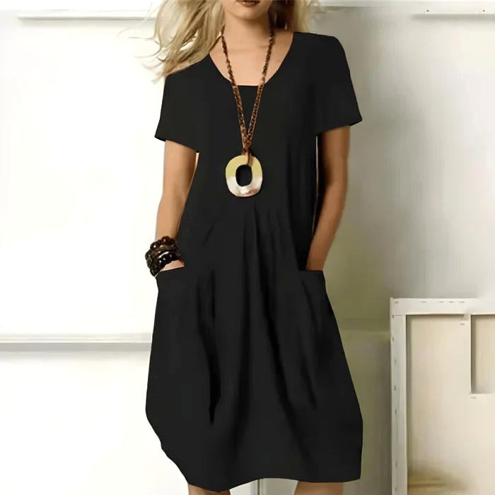 Comfortable women's short sleeve relaxed midi dress with pockets, ideal for casual spring & summer wear.