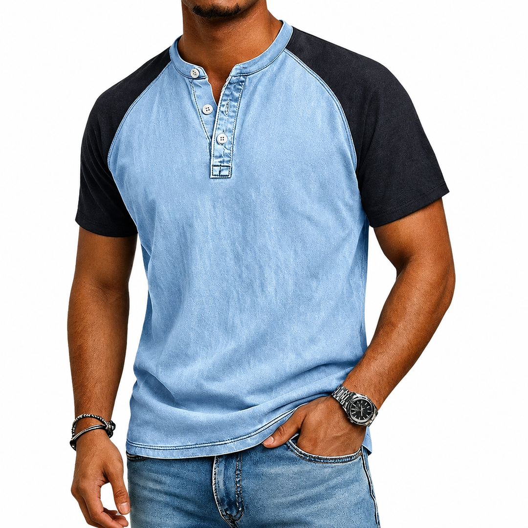 Close-up of a men's two-tone Henley t-shirt, highlighting the button placket and quality casual fabric.