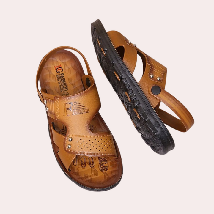 Close-up of men's dark brown slides, highlighting the riveted buckle strap detail. Ideal for beachwear.