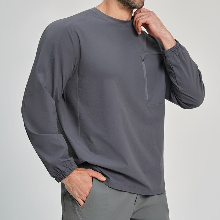 Sporty men's black long sleeve fishing shirt with crew neck & secure zip pocket for active outdoor wear.