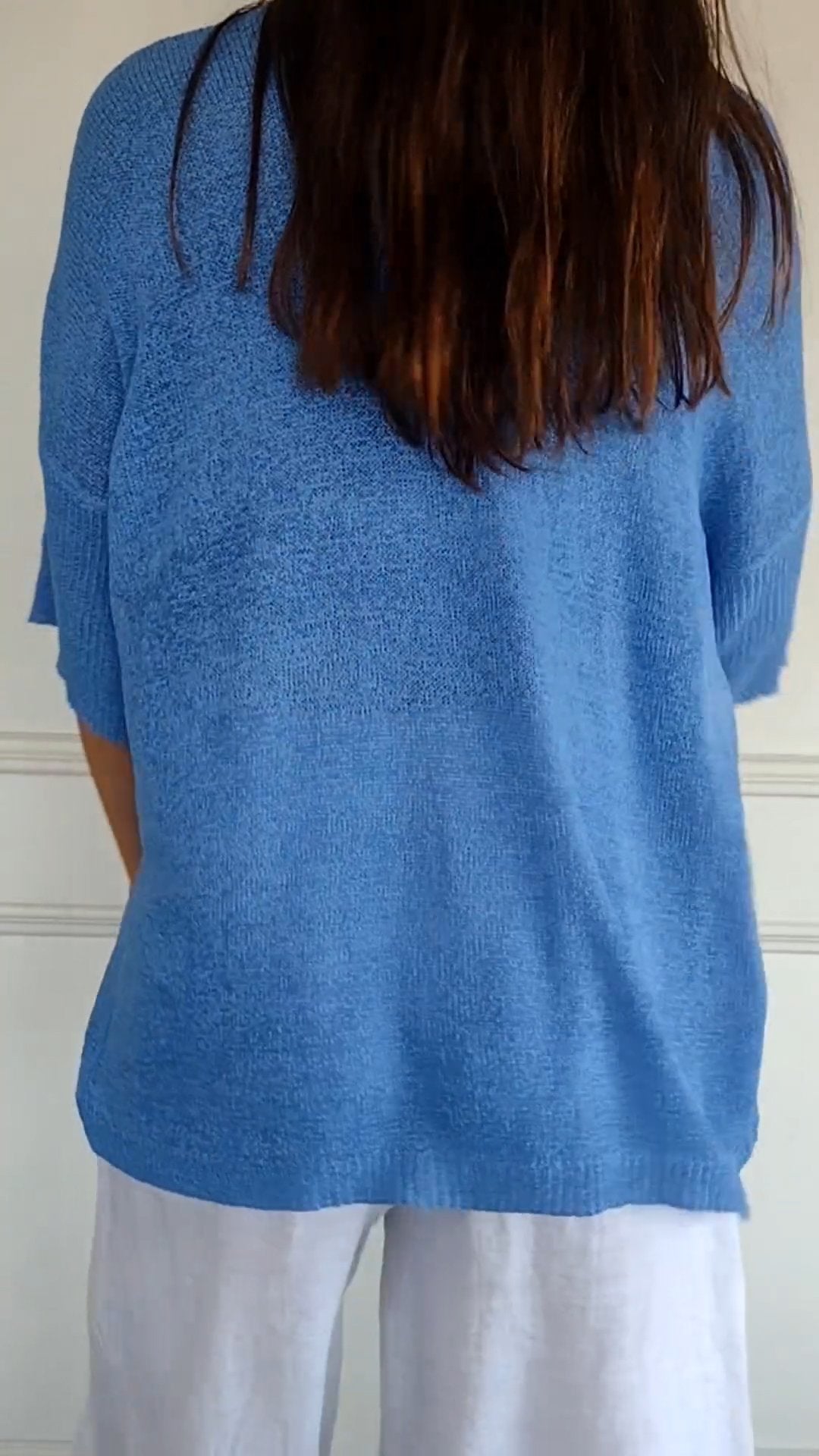 Woman models a chic V-neck long sleeve top, showcasing its versatile style and comfortable fit. [[lstfy-media:11]]
