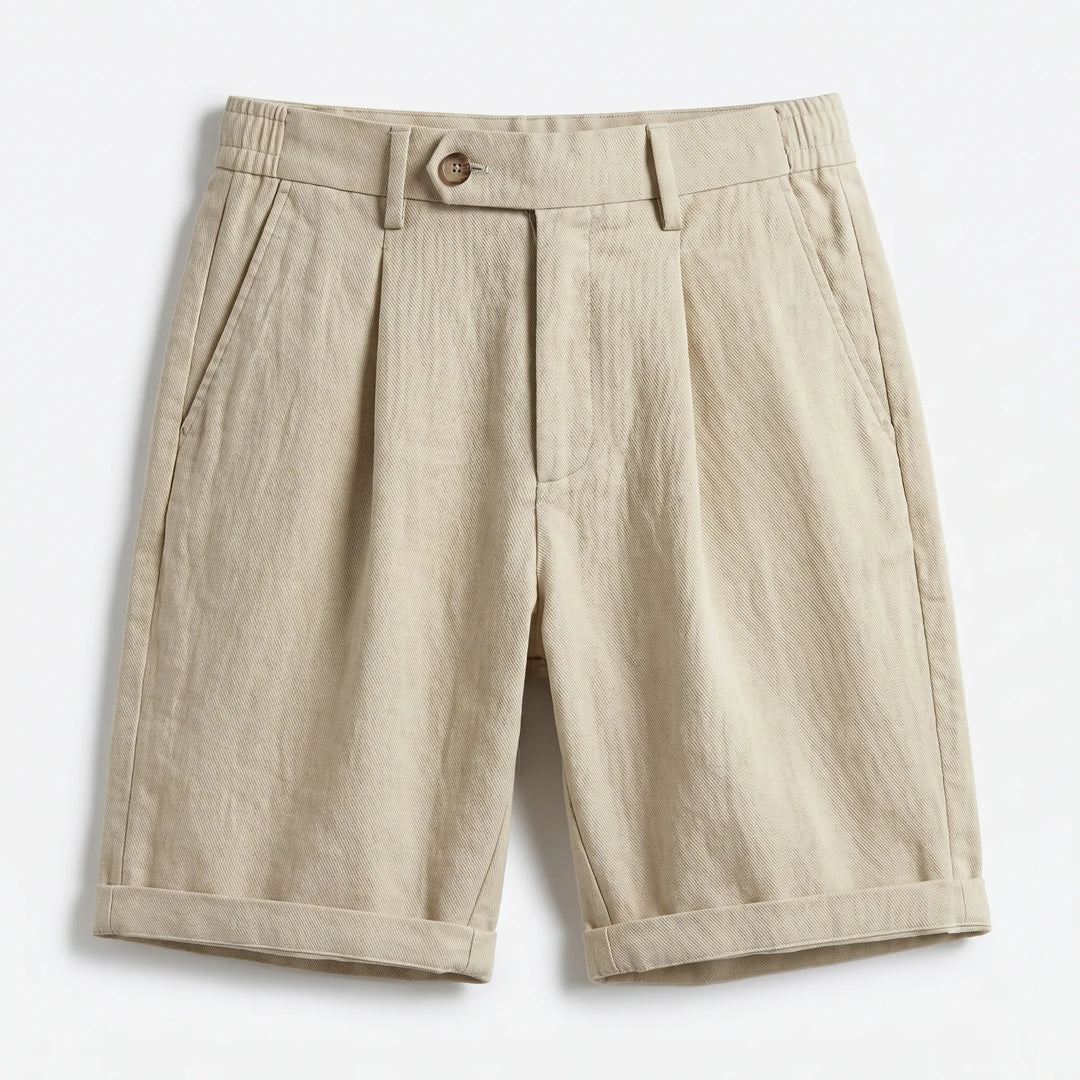 Close-up of men's tailored linen pleated shorts, showcasing fabric texture & stylish turn-up cuff. Summer casual.